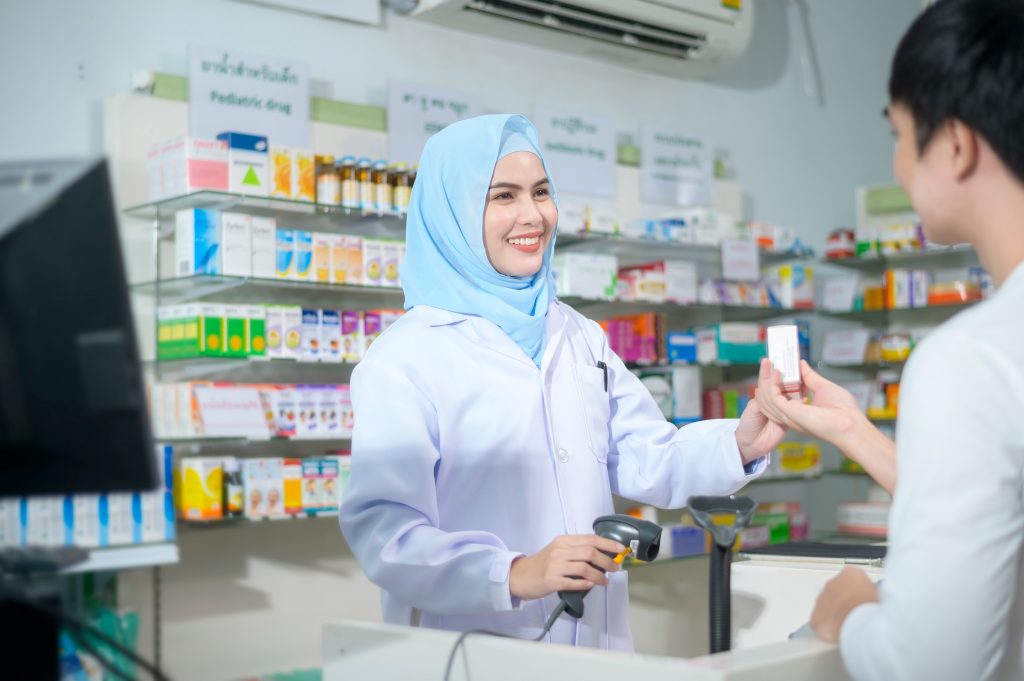 Muslim pharmacist counseling customer about drugs usage